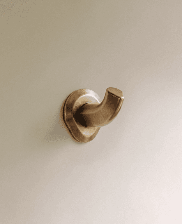 Enzo Wall Hook Color: Unlacquered Brass, Dimensions: 2.39" x 1.59" x 1.77", Overall projection: 2.39" from the wall, Height: 1.77", Includes: Screws and fixings, 1 yr Wrrty